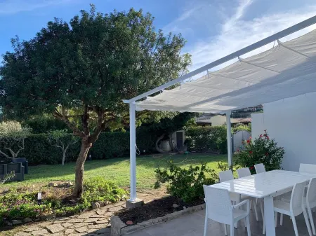 Villa with large garden a few steps from the beautiful beach of Costa Rei Отели в г. Costa Rei