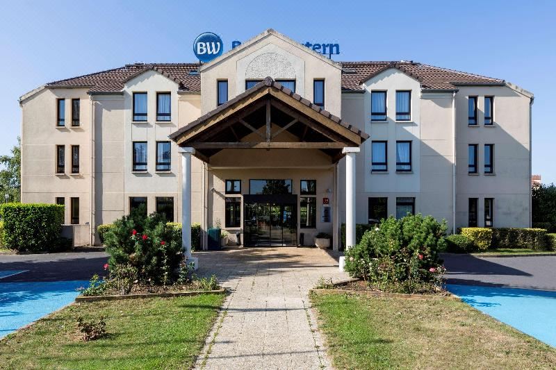 "a large hotel with a covered entrance and a sign that says "" bw comfort suites "" on top" at Best Western the Public Hotel