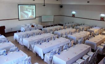 a large conference room with tables and chairs set up for a meeting or event at Riverside Apartments