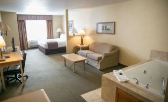 a hotel room with a bed , couch , and table is shown in the image above at Thumper Pond Resort