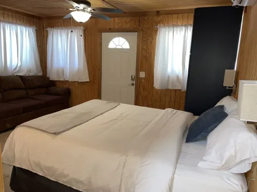 Studio cabin #2 with lake view, boat dock access, outdoor seating, and firepit.