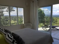 Luxurious villa set in a vast tropical garden, with panoramic sea and nature views.