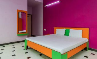 a large bed with a pink and orange headboard is in a room with pink walls at Holiday Inn