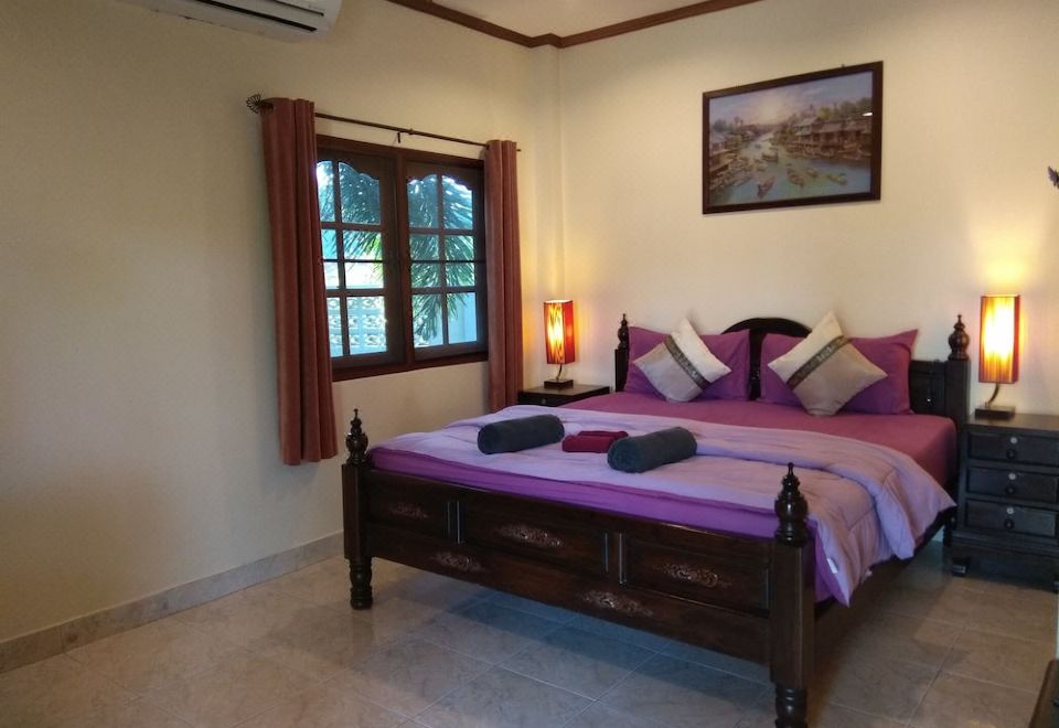a large bedroom with a king - sized bed and a large window , allowing natural light to fill the room at Stella Resort
