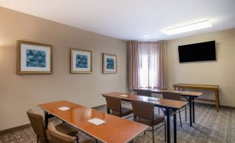 a conference room with several tables and chairs arranged for a meeting or training session at Staybridge Suites Milwaukee Airport South