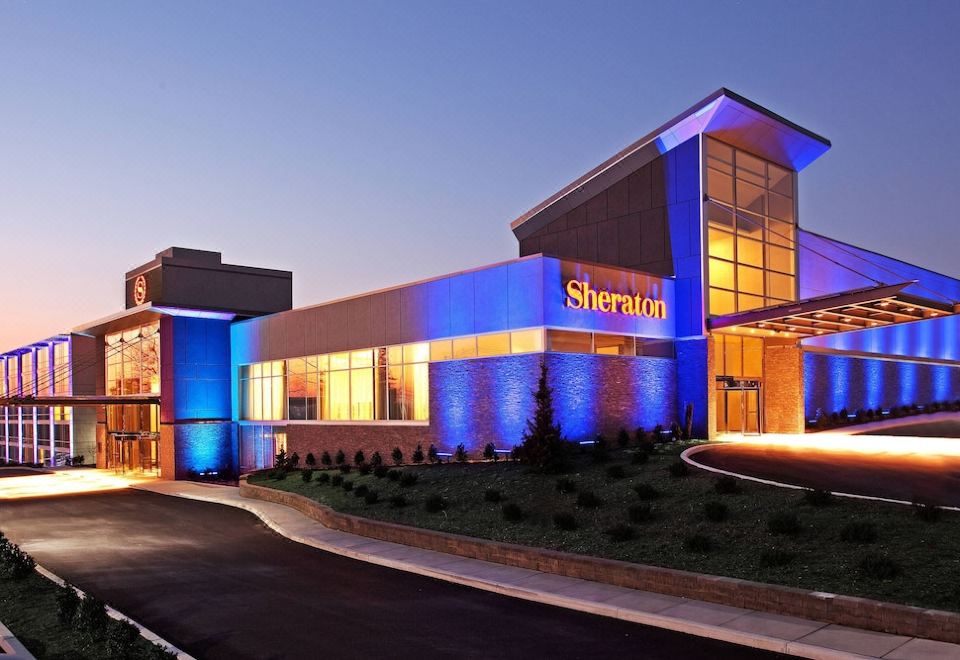 "a large , modern building with the word "" sheraton "" on it is lit up at night" at Sheraton Valley Forge King of Prussia