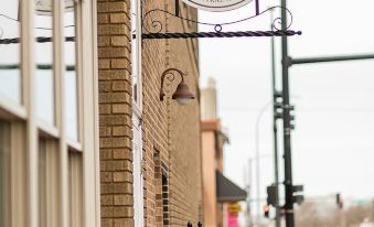 "a brick building with a sign that reads "" inn on central "" hanging from the side of the building" at Inn on Central