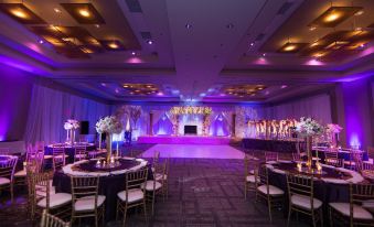a large room with purple lights and a stage decorated for a party or event at Raleigh Marriott City Center