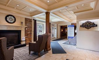 a hotel lobby with a brick fireplace and a large sign above it , inviting guests to enter at Best Western Parkway Inn  Conference Centre