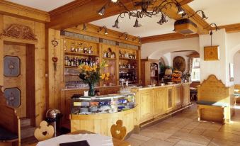 a restaurant with a wooden interior and a bar area , featuring a dining table and chairs at Hotel Villa Argentina