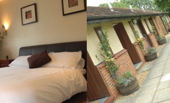 a bedroom with a bed and two framed pictures is shown next to an image of a brick house at The Carrington Arms