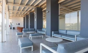 a large , modern office space with multiple couches and chairs arranged in a sitting area at Casa Andina Standard Talara