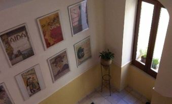 a yellow staircase with framed pictures hanging on the wall , creating a vibrant and inviting atmosphere at Buena Vista B&B