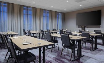 a large , empty conference room with multiple tables and chairs arranged for a meeting or event at Courtyard Pasco Tri-Cities Airport