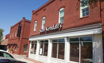 "a brick building with a sign that reads "" sam kendall 's "" prominently displayed on the front of the building" at The Mantissa Hotel