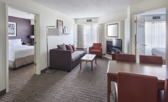 a hotel room with a comfortable living area , a couch , a dining table , and a television at Residence Inn Cranbury South Brunswick