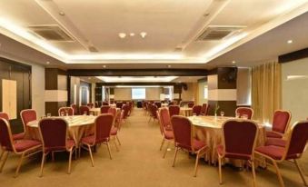 a large dining room with multiple tables and chairs arranged for a group of people to enjoy a meal together at Golden Flower by Kagum Hotels