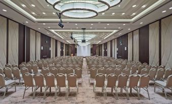 a large conference room with rows of chairs arranged in a semicircle , ready for a meeting or event at Doubletree by Hilton Istanbul Umraniye