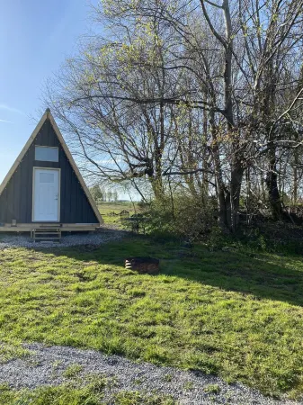 King bed in Tulip Glamping Aframe at Noble Pine Campground