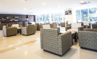 a spacious waiting area with several chairs and couches , creating a comfortable and inviting environment for guests at Golf Phu My Hotel