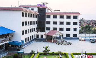 "a large white building with a sign that says "" nepal hotel "" in blue and red letters" at Suva Hotel