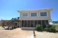 TROUT Steps to beach. Lovely two bedroom with screened porch and pool.