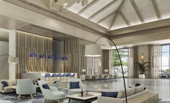 a modern hotel lobby with a variety of seating options , including couches , chairs , and other furniture at Rixos Water World Aktau