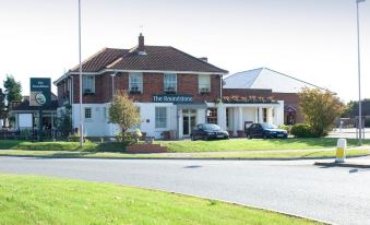 "a brick building with a sign that says "" the bishopfield "" and parked cars in front of it" at Premier Inn Littlehampton