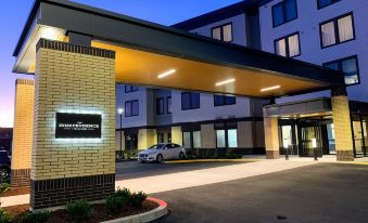 "a hotel entrance with a car parked in front of it and the name "" proteus hotel "" on the building" at The Independence Hotel