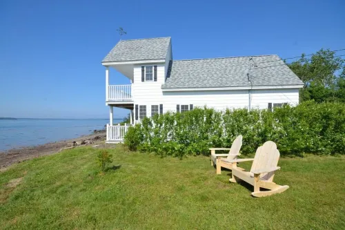 Sea-Breeze Cottage perched on the edge of the bay.