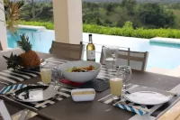 Luxurious villa set in a vast tropical garden, with panoramic sea and nature views.