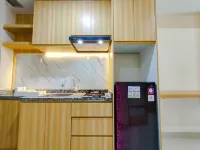 Wood Accents Studio at Grand Dharmahusada Lagoon Apartment by Travelio