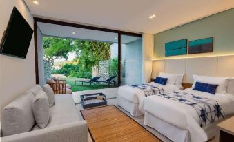 a bedroom with a bed , couch , and sliding glass door leading to an outdoor patio at Wyndham Ilhabela Casa di Sirena