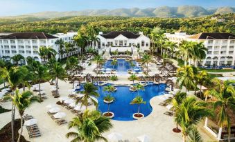 An aerial view of a pool in a large city resort or water park at The Ritz-Carlton Golf & Spa Resort, Rose Hall, Jamaica