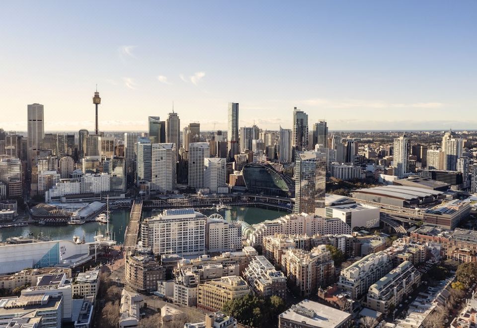 aerial view of a modern city with tall buildings and skyscrapers , including the sydney opera house at Novotel Sydney Darling Harbour