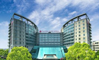 "There is a large building with an exterior view that has the word ""hotel"" displayed on top, located in front" at Ramada Plaza by Wyndham Shanghai Pudong Airport