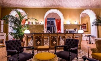 a well - decorated bar area with several chairs and couches , creating a comfortable and inviting atmosphere at Chateau de Sacy