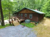 Secluded cabin surrounded by mountains, waterfalls, wildlife, and 50,000 acres