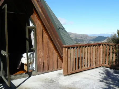 Log cabin in the mountains with indoor climbing wall, perfect for a family.