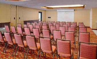 a conference room with rows of chairs arranged in a semicircle , ready for a meeting at Residence Inn Palo Alto Los Altos