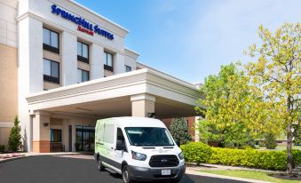 "a white van is parked in front of a hotel with a sign that says "" springhill suites ""." at SpringHill Suites Cleveland Solon