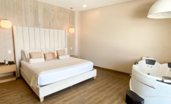a large bed with white linens and a wooden headboard is in a room with a white wall at Acantilados