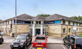 "a car is parked in front of a building with the sign "" travelodge "" on it" at Travelodge Stafford M6