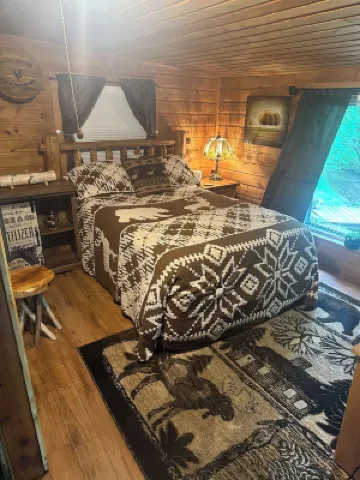 A Stream  runs through it. Comfy little cabin with a stream by your bedroom.