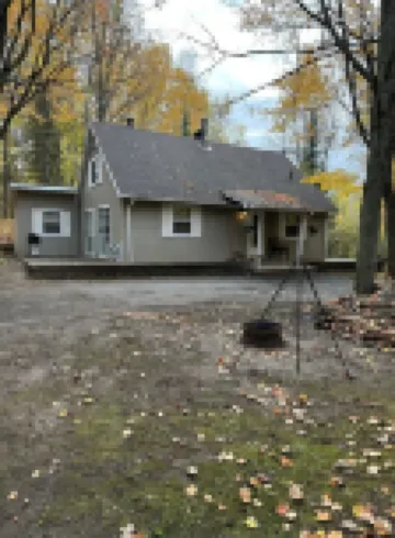 Cozy vacation home nestled in a quiet wooded area. Near town but private