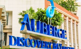 The logo or sign for a hotel, Atlantis International Airport and Convention Center, needs to be reviewed and revised for grammatical accuracy, clarity, and coherence, while summarizing the main information in one sentence at Auberge Discovery Bay Hong Kong