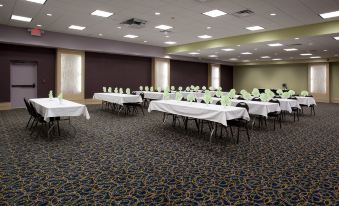 a large conference room with multiple tables and chairs arranged for a meeting or event at Holiday Inn Rock Springs