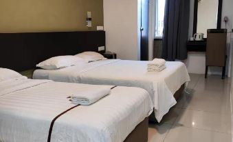 a hotel room with two beds , one on the left and one on the right side of the room at Comfort Inn