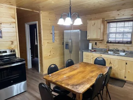 2BR 1 Bath cabin w/ full kitchen, hot tub, and living room.