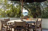 All day sun house with metres away from the golden sands of Onetangi Beach.